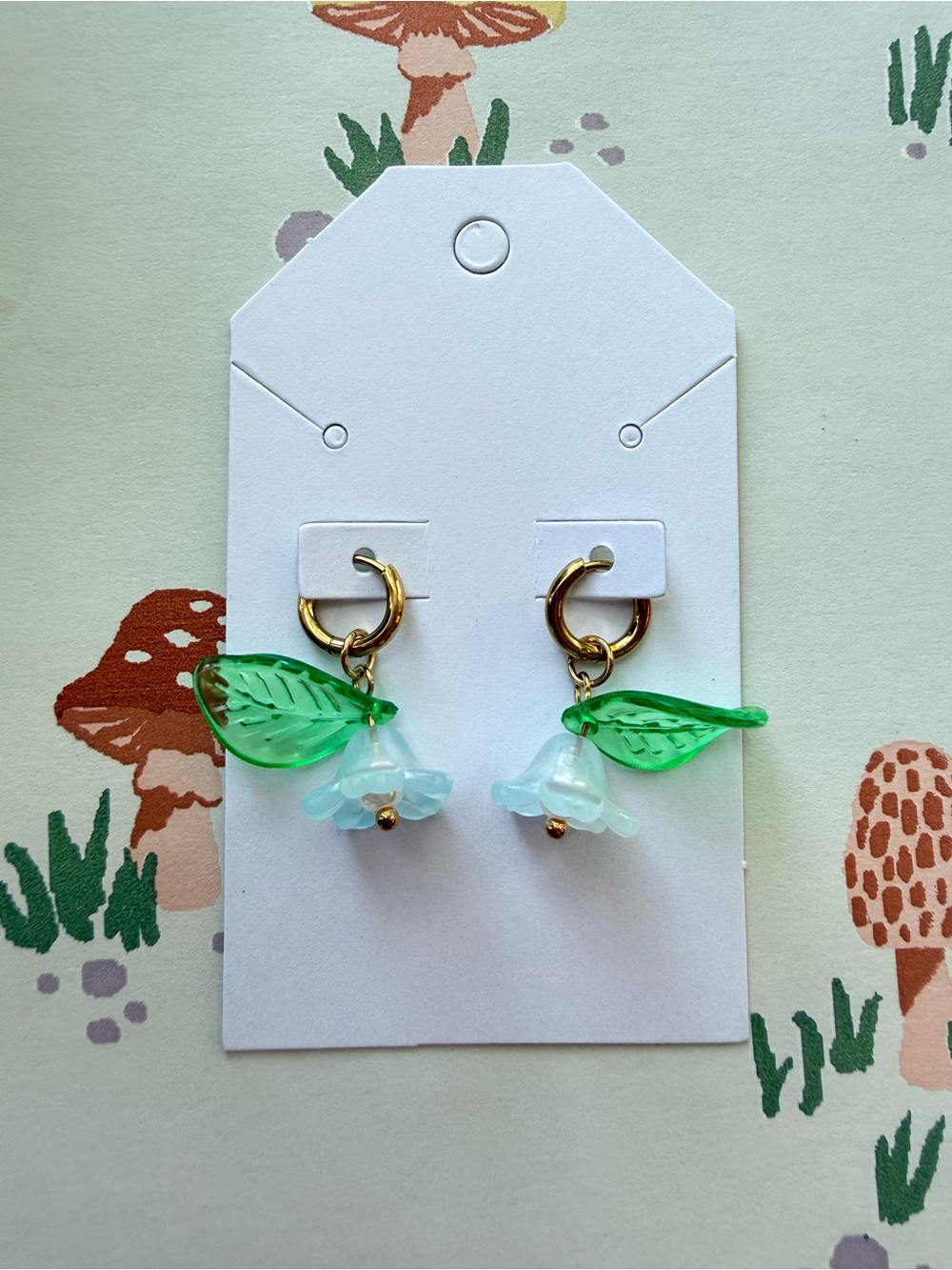 Gold Hoop Earrings with Green Leaf and Light Blue Flower Charms